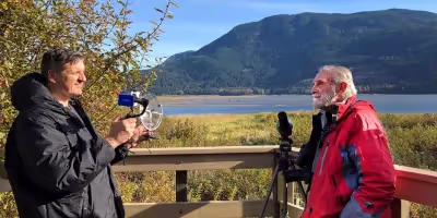 a Sound Shark long-range microphone being used by a vlogger to interview a guest