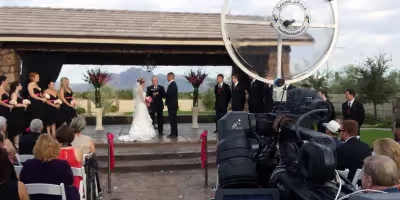 a Sound Shark long-range microphone being used on a video camera at an outdoor wedding