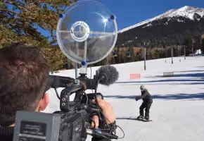 Video camera with a Sound Shark long-range microphone on ski hill