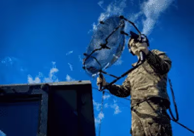 A soldier holding a KLOVER MiK 26 Stealth parabolic microphone