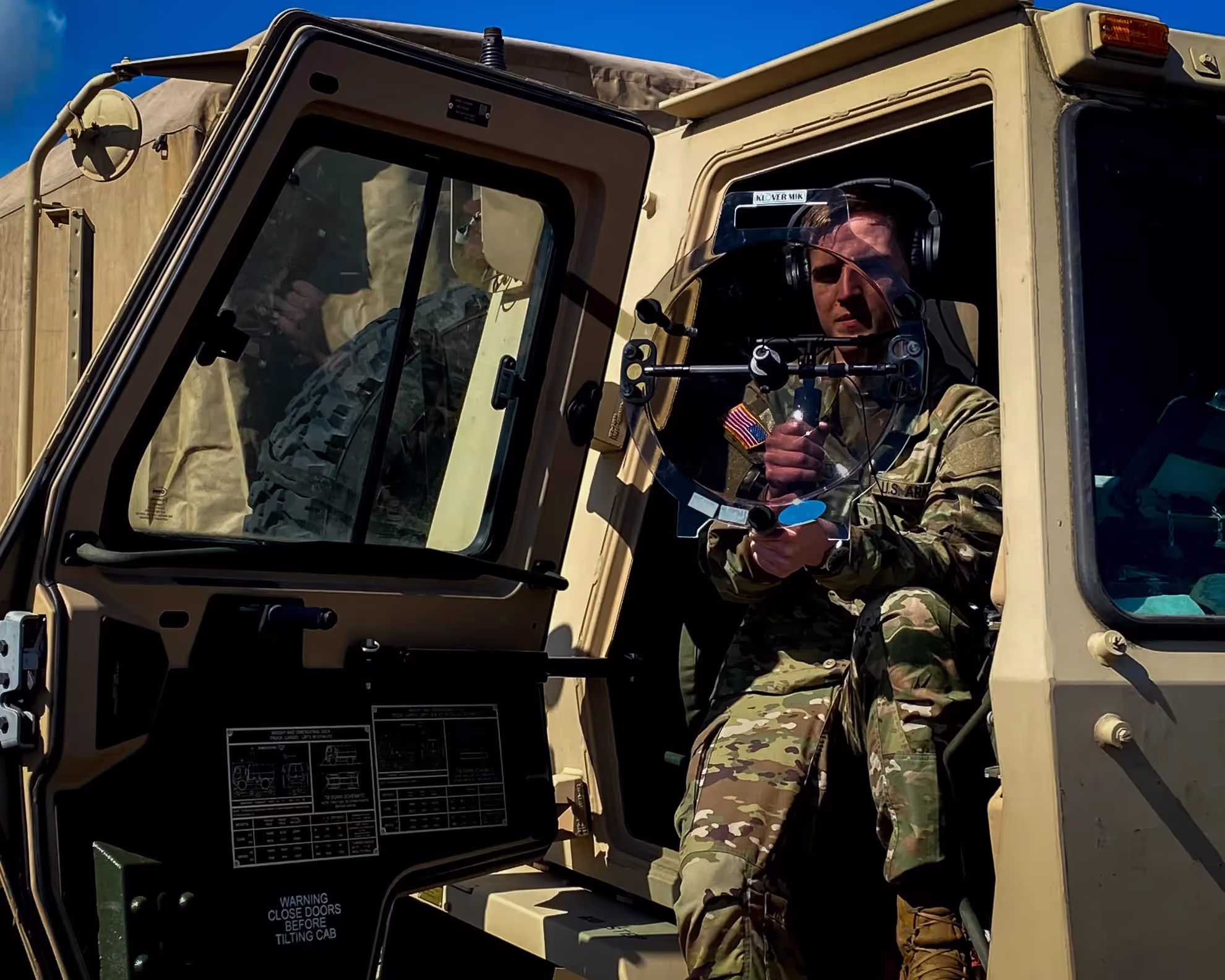 A soldier holding a KLOVER MiK 16 Stealth parabolic microphone