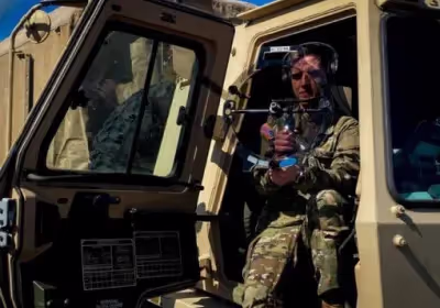 A soldier holding a KLOVER MiK 16 Stealth parabolic microphone