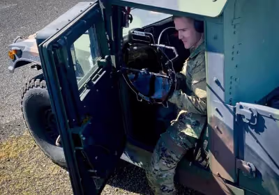 A soldier holding a KLOVER MiK 16 Stealth parabolic microphone