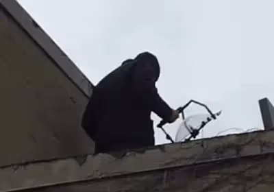 A security officer holding a KLOVER MiK 16 Stealth parabolic microphone